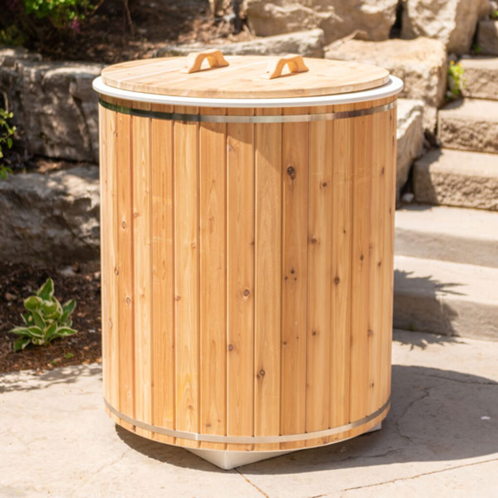 Baltic Plunge Tub with white HDPE plastic and cedar skirt surrounded by stainless steel bands, promoting wellness and relaxation.