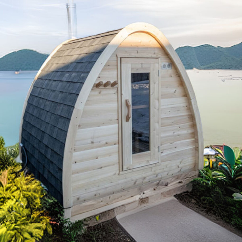  "Compact yet spacious CT MiniPOD Sauna from Dundalk LeisureCraft, crafted from sustainable white cedar with black asphalt shingle roof, suitable for both wood-burning and electric heaters."