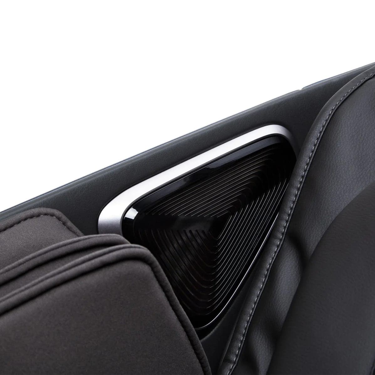 Close-up of triangular built-in speaker on massage chair shoulder panel
