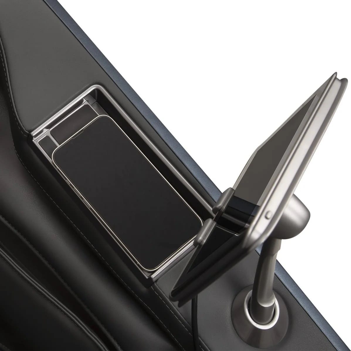 Close-up of massage chair armrest with open wireless charging tray and tablet remote