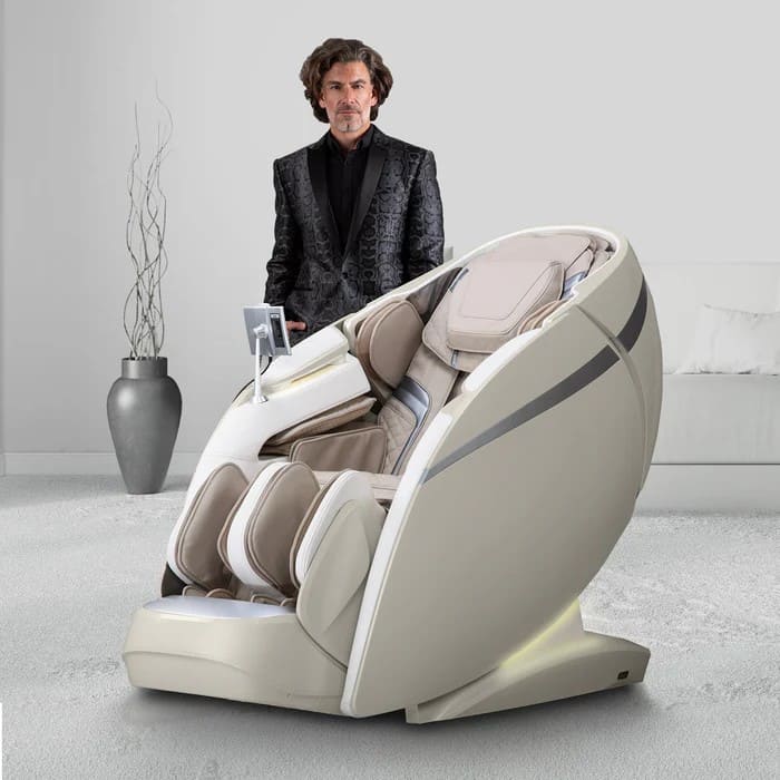 Man in black suit standing beside the Osaki OS-Pro 4D DuoMax massage chair in taupe
