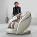 Man in black suit standing beside the Osaki OS-Pro 4D DuoMax massage chair in taupe
