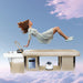 Woman floating over a beige shampoo bed with white sink