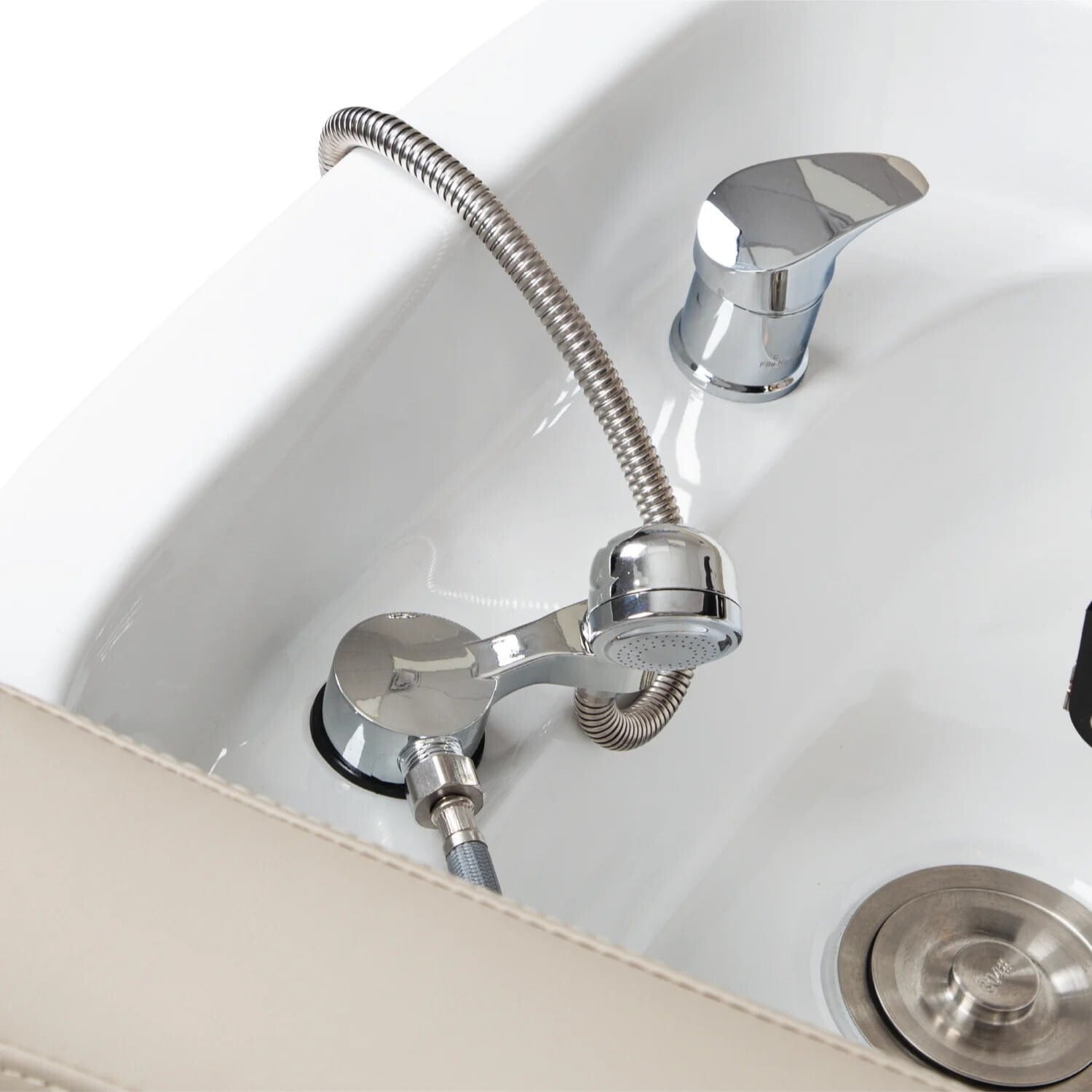 Closeup of shampoo bed sink with faucet and drain