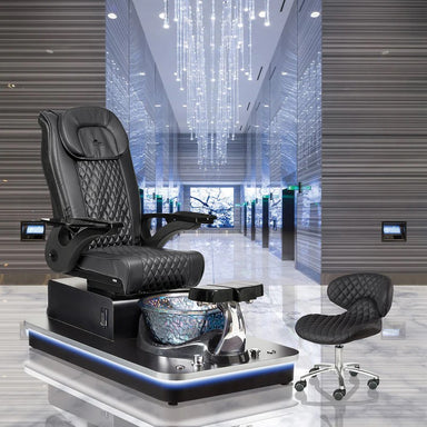 Modern black pedicure chair in luxurious setting with technician stool