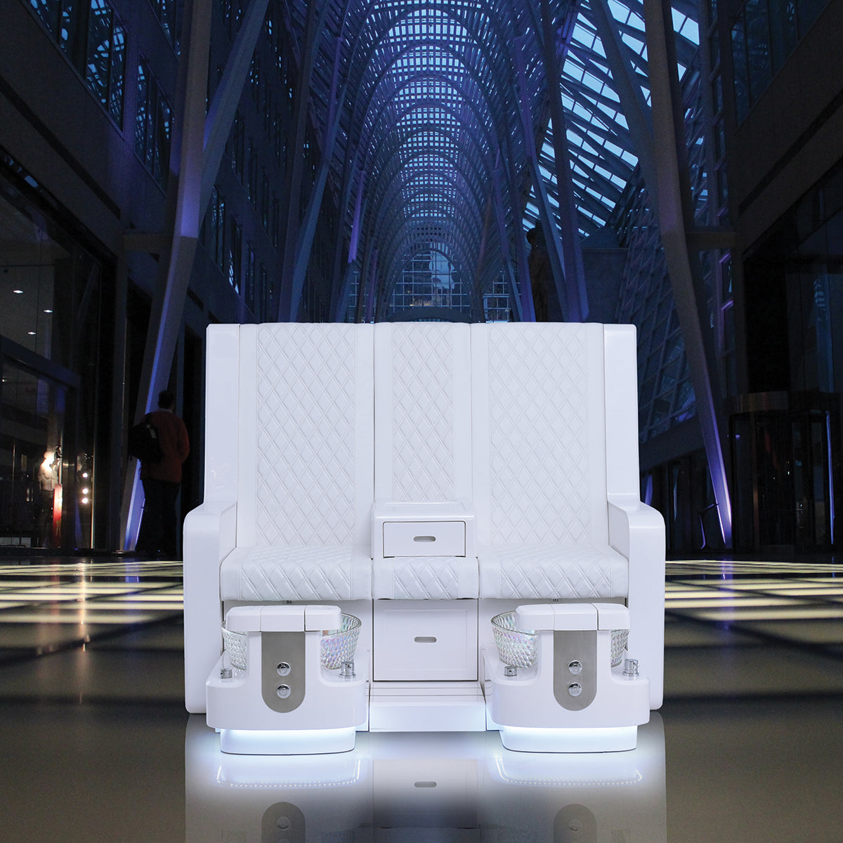 White double pedicure bench featured in futuristic indoor setting