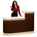 Lady in red shirt standing next to brown reception desk with LED lighting