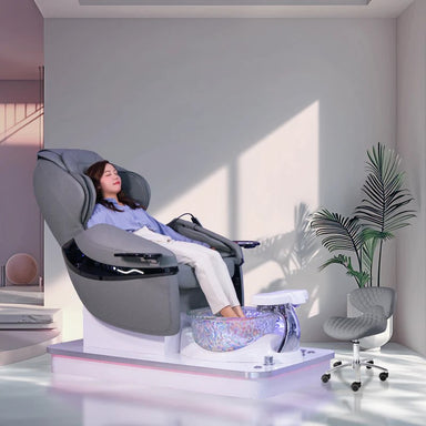 Woman relaxing in gray pedicure chair in luxurious setting