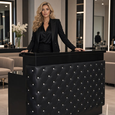 Woman in modern salon standing behind reception desk