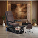 Chocolate colored pedicure chair on black base with smoke bowl amidst luxury setting