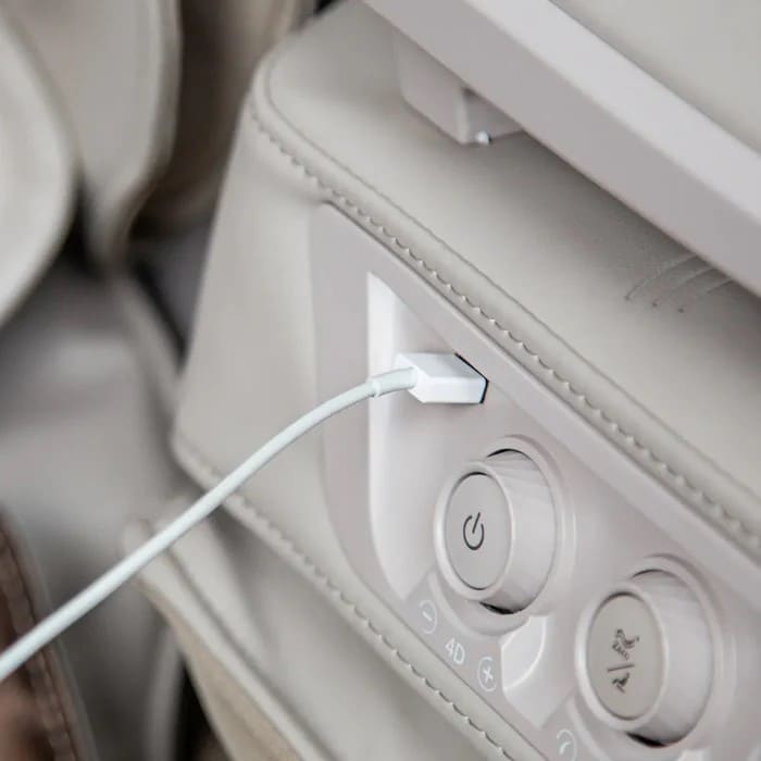 Close-up of USB charging port and control buttons on the OS-Pro 4D DuoMax SE armrest

