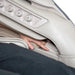 Hand demonstrating arm massage feature inside the OS-Pro 4D DuoMax SE side panel
